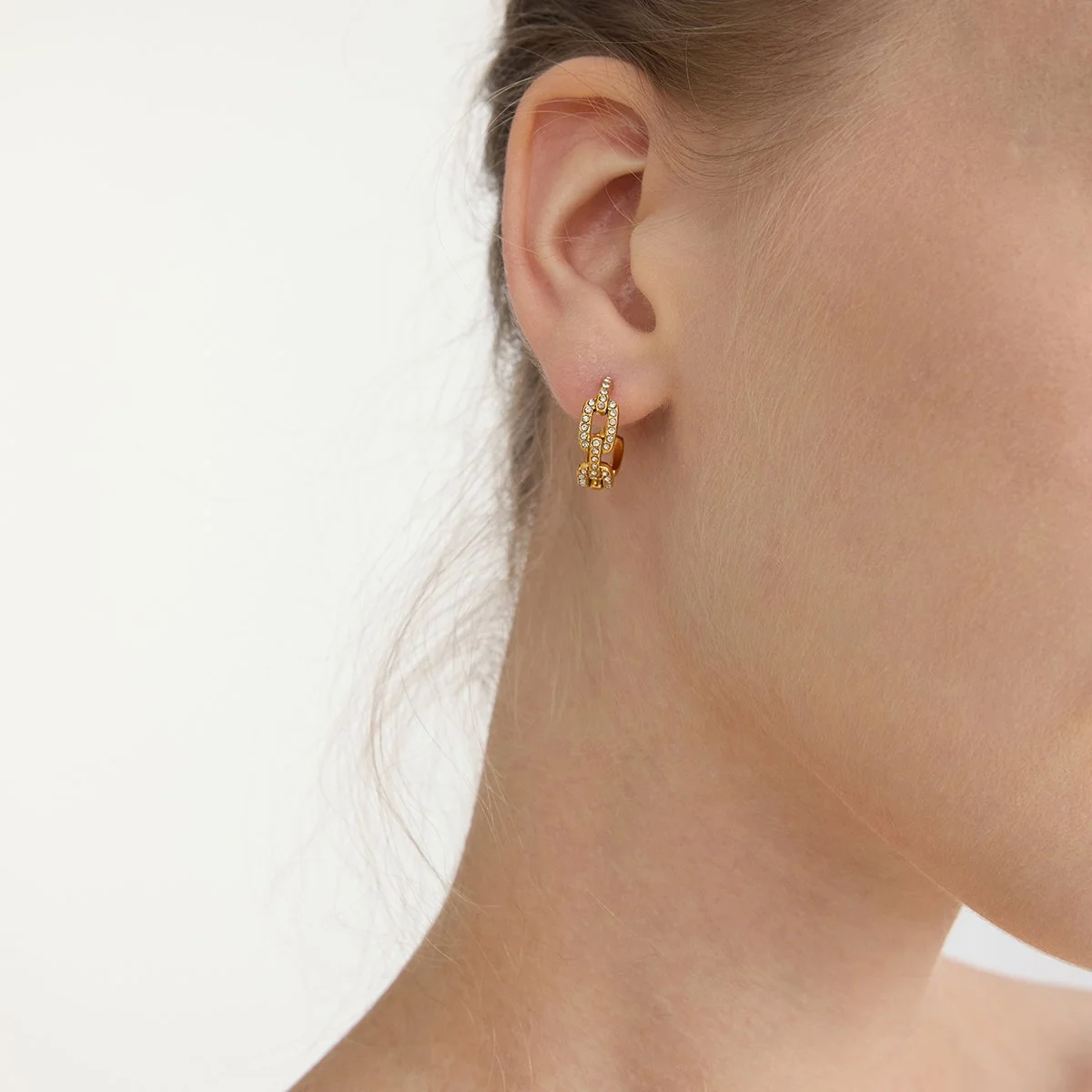Small gold diamond hoop earrings.