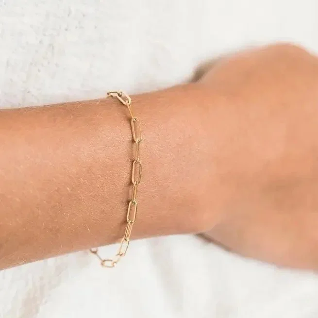Delicate Chain Link Bracelet worn on wrist, showcasing a versatile and feminine jewelry style perfect for stacking or wearing alone.