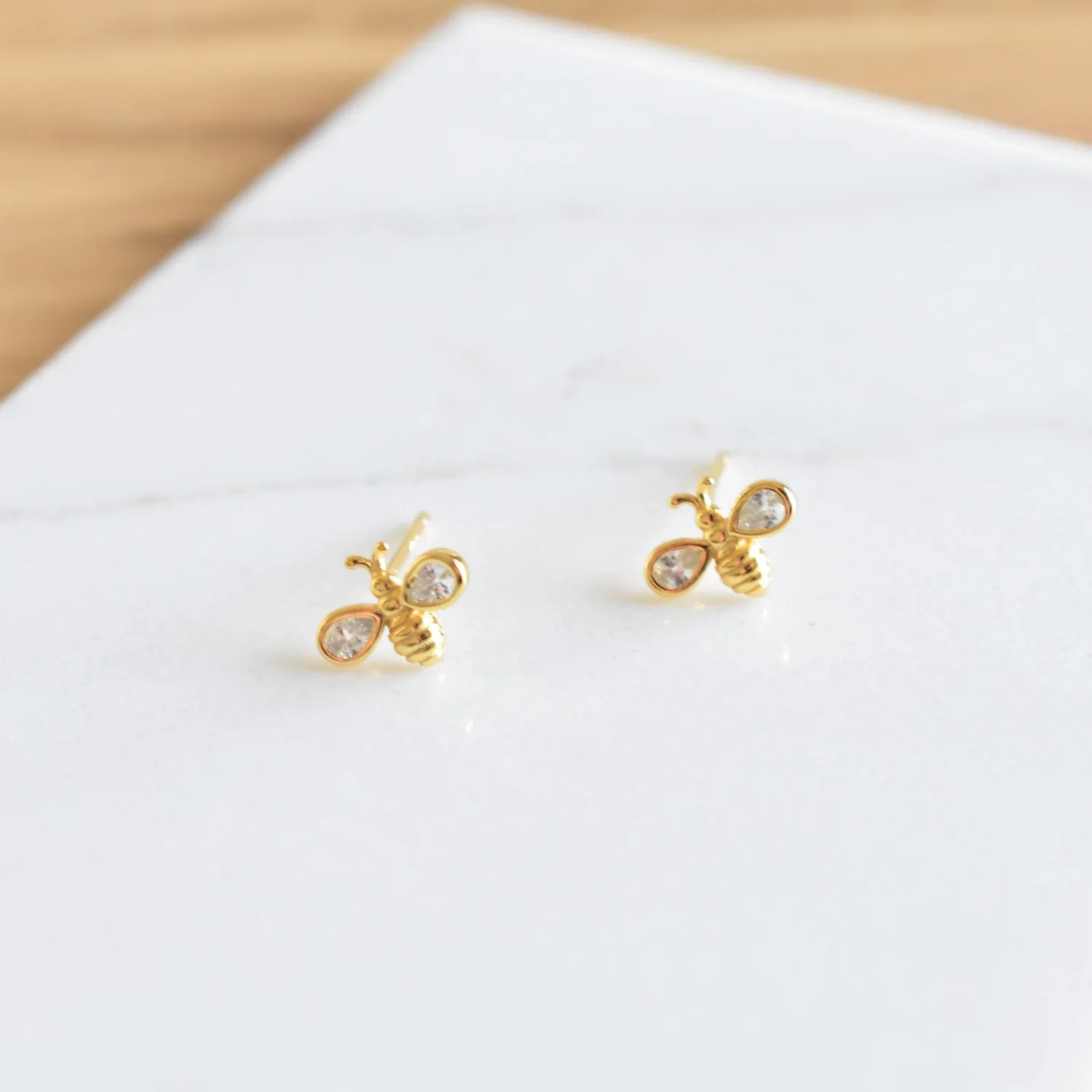 Close-up of Gold Honey Bee CZ Stud Earrings highlighting the intricate honey bee details, shimmering CZ stones, and elegant gold setting.