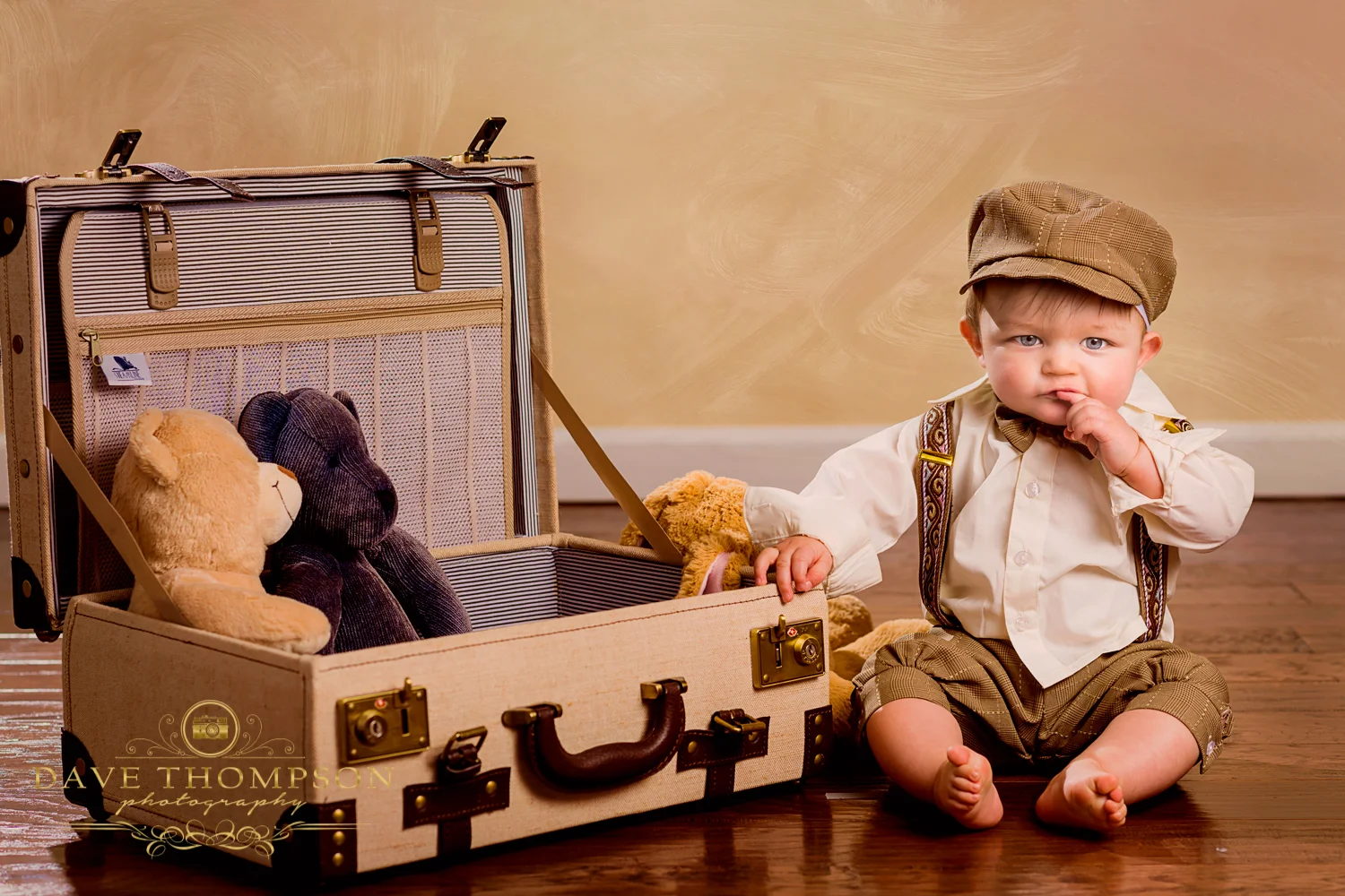 Another fund family photo. The background was modified to add a texture, adding interest. The suitcase and stuffed animals add whimsical fun to this toddler photo.