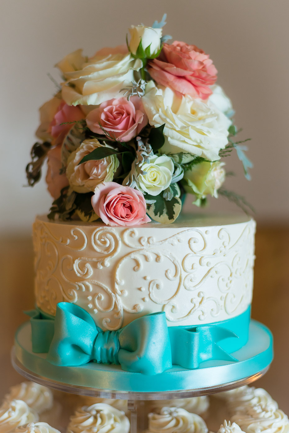 Floral Wedding Cake with Bow and Cupcakes