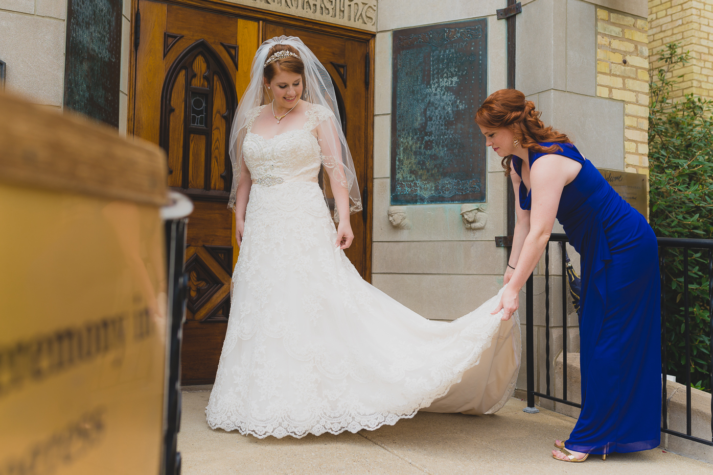 Sister helping with wedding dress