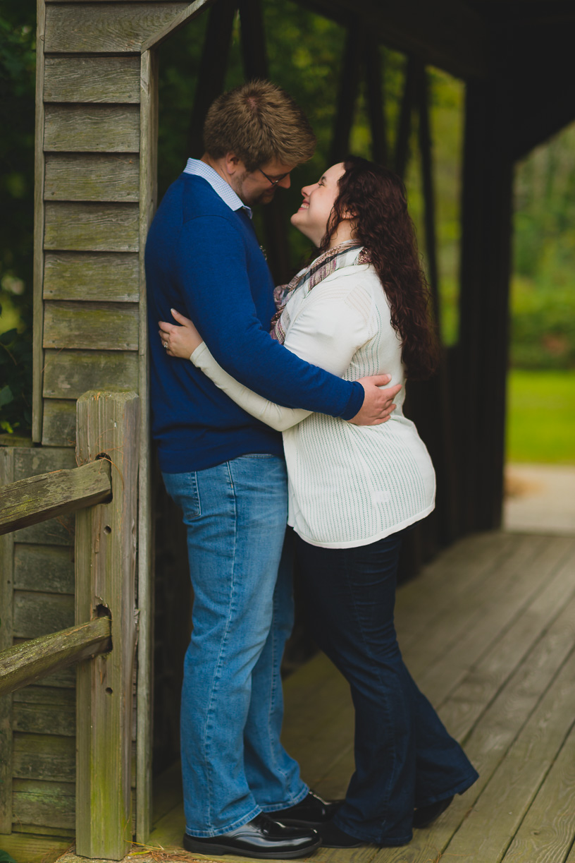 Covered bridge couple laughing