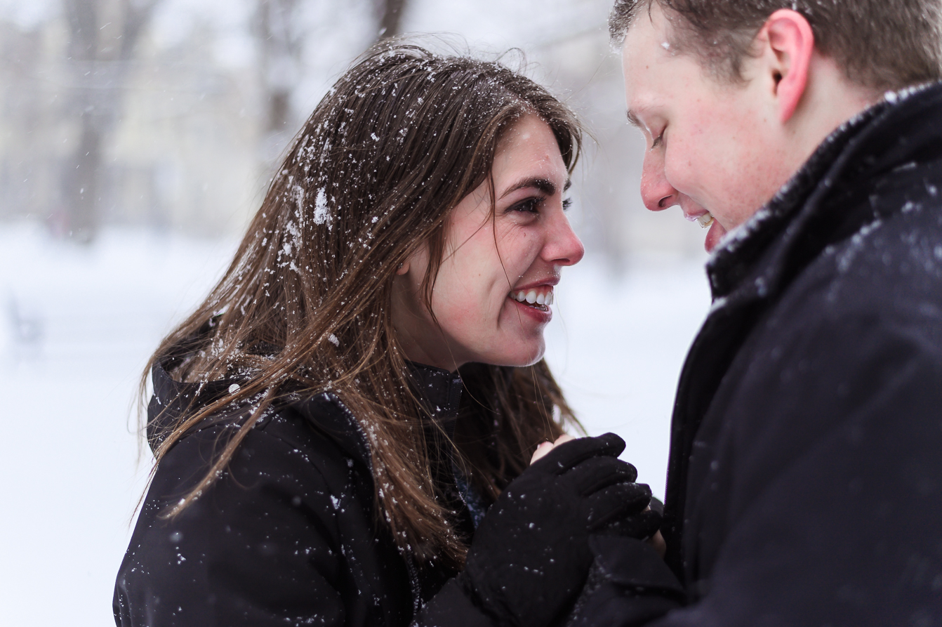  A cute couple in the middle of a snowball fight for the camera for enagement memories. 