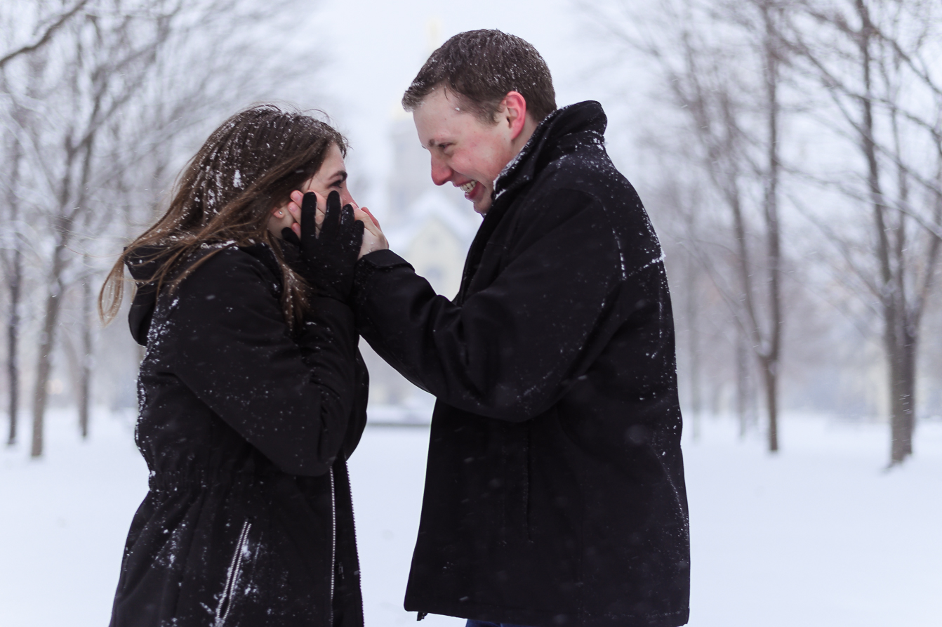  A cute couple in the middle of a snowball fight for the camera for enagement memories. 