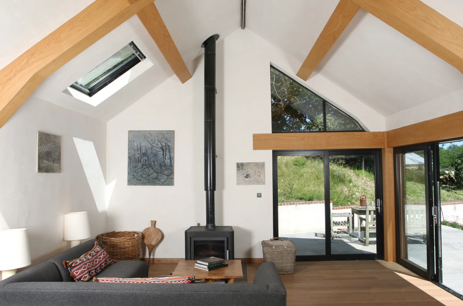 The large 70M² contemporary extension can be accessed through the older part of the property or via two large sliding glazed doors on the terrace. Well serviced by a large kitchen, the dining and sitting area both have stunning views across the terrace to the lake and countryside beyond.