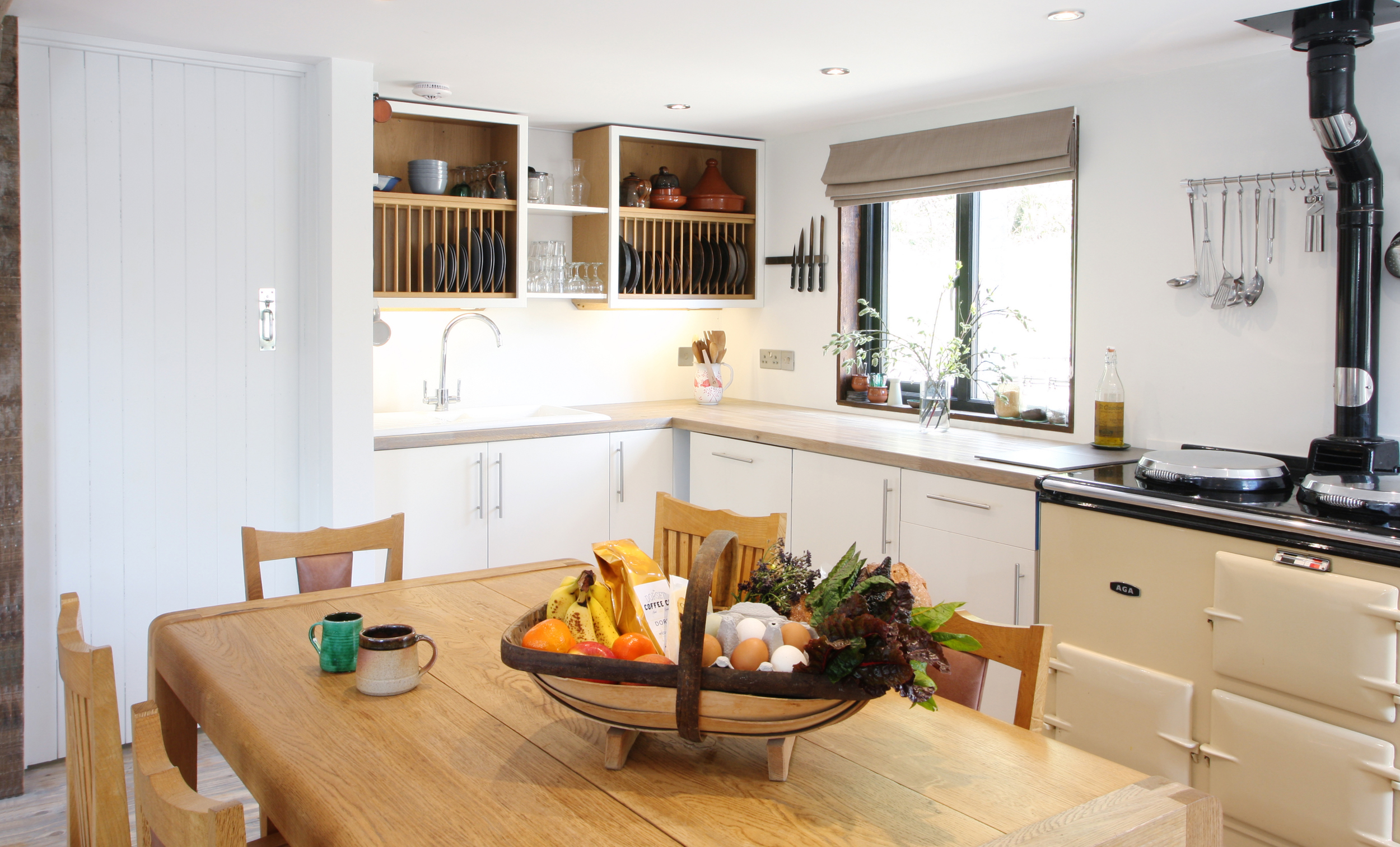 The Kitchen dining area with Aga and Radius Table by Simon Pengelly is a welcoming space to return to and enjoy creating fantastic meals from fresh local produce.