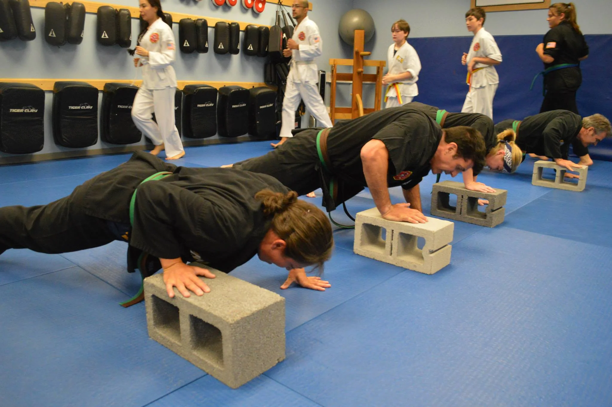 Linda performing a push up exercise with cinderblocks.