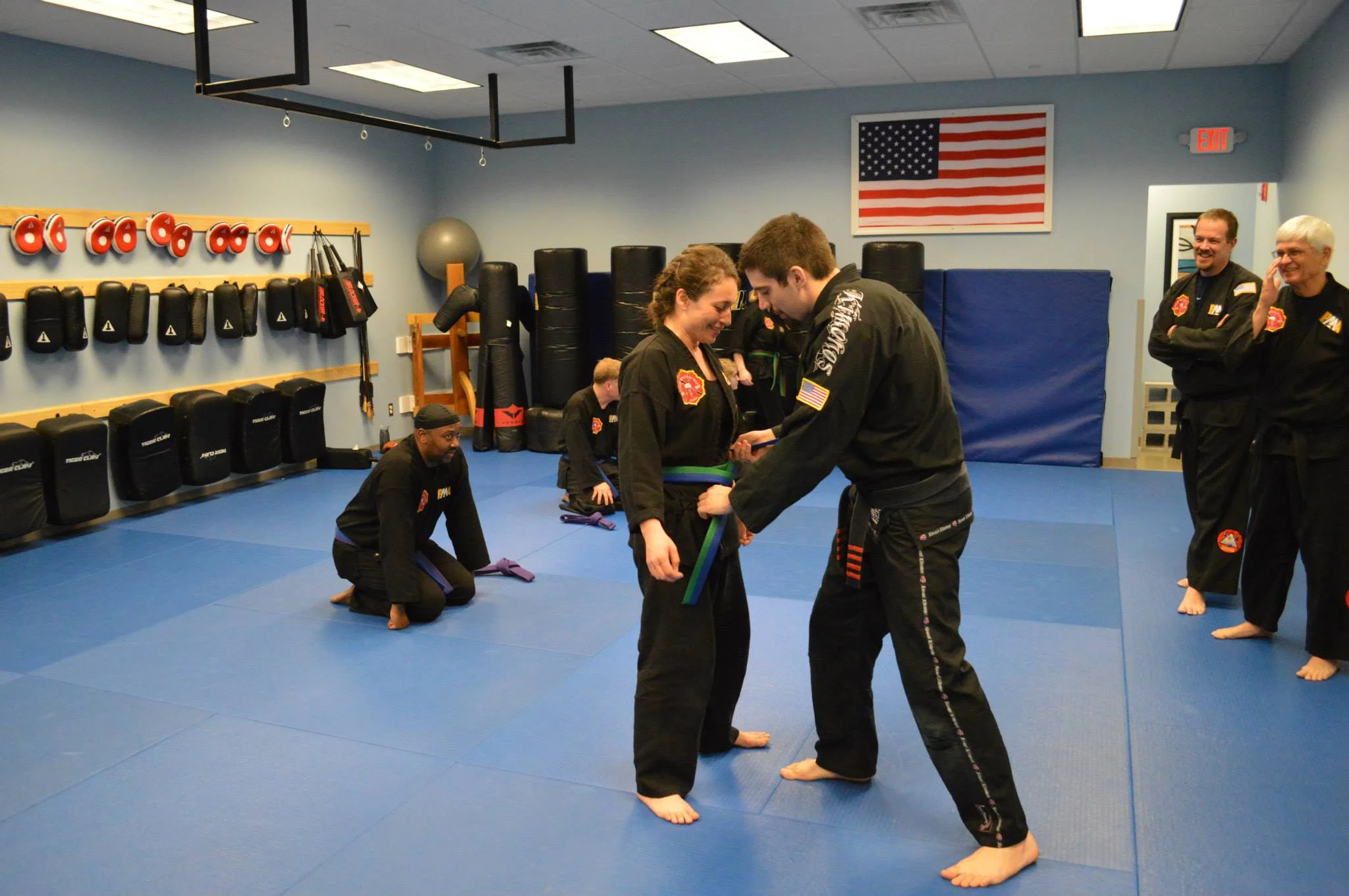 Linda receiving a promotion from her SiFu, David Corrigan.