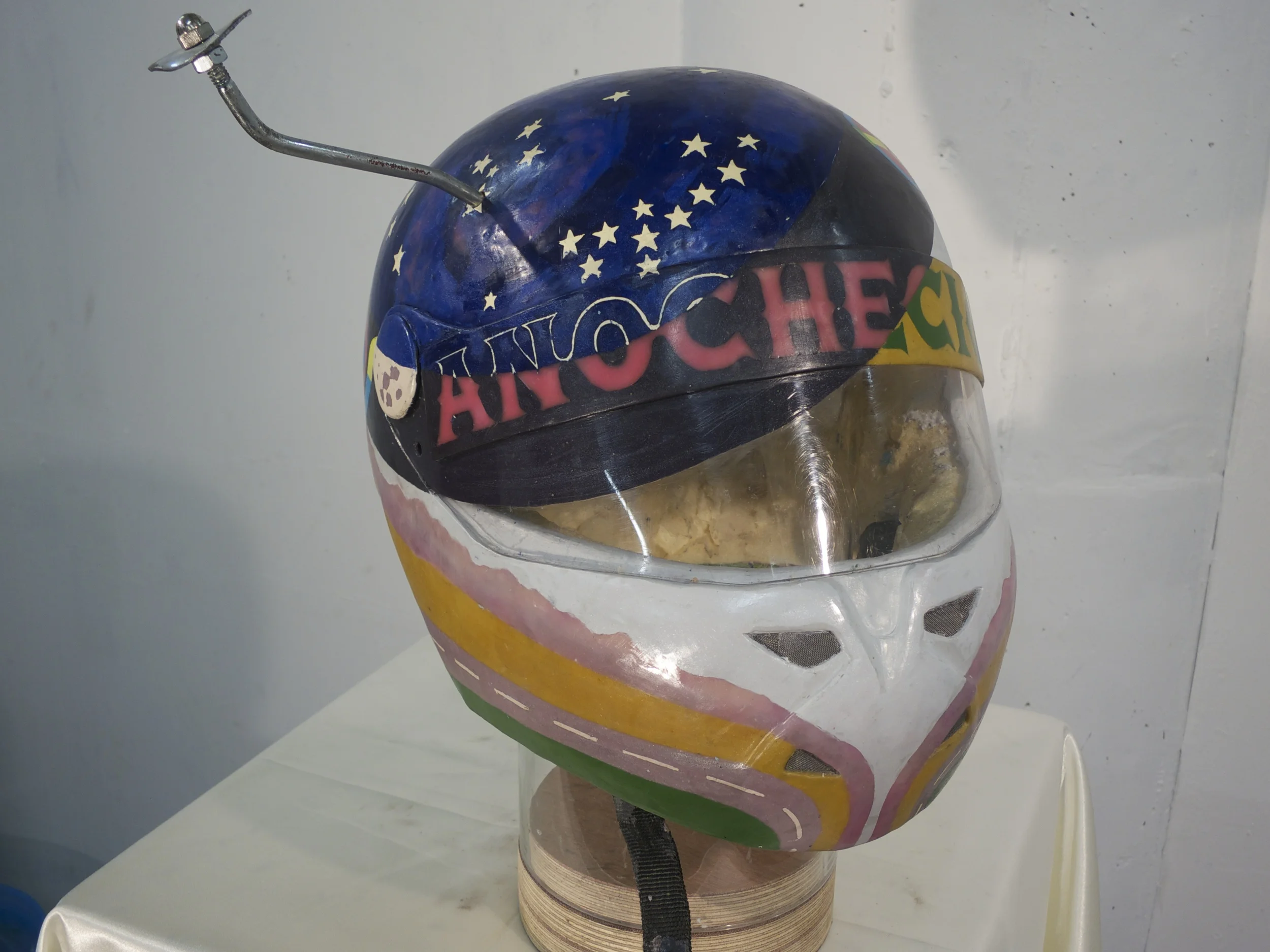 y en sus ojos anocheció, 2012. Modified motorcycle helmet, Bondo resin, natural Peruvian (Andean) dyes, beeswax, dammar resin, encaustic pigments, expanding foam. 12.5" x 17" x 15"
