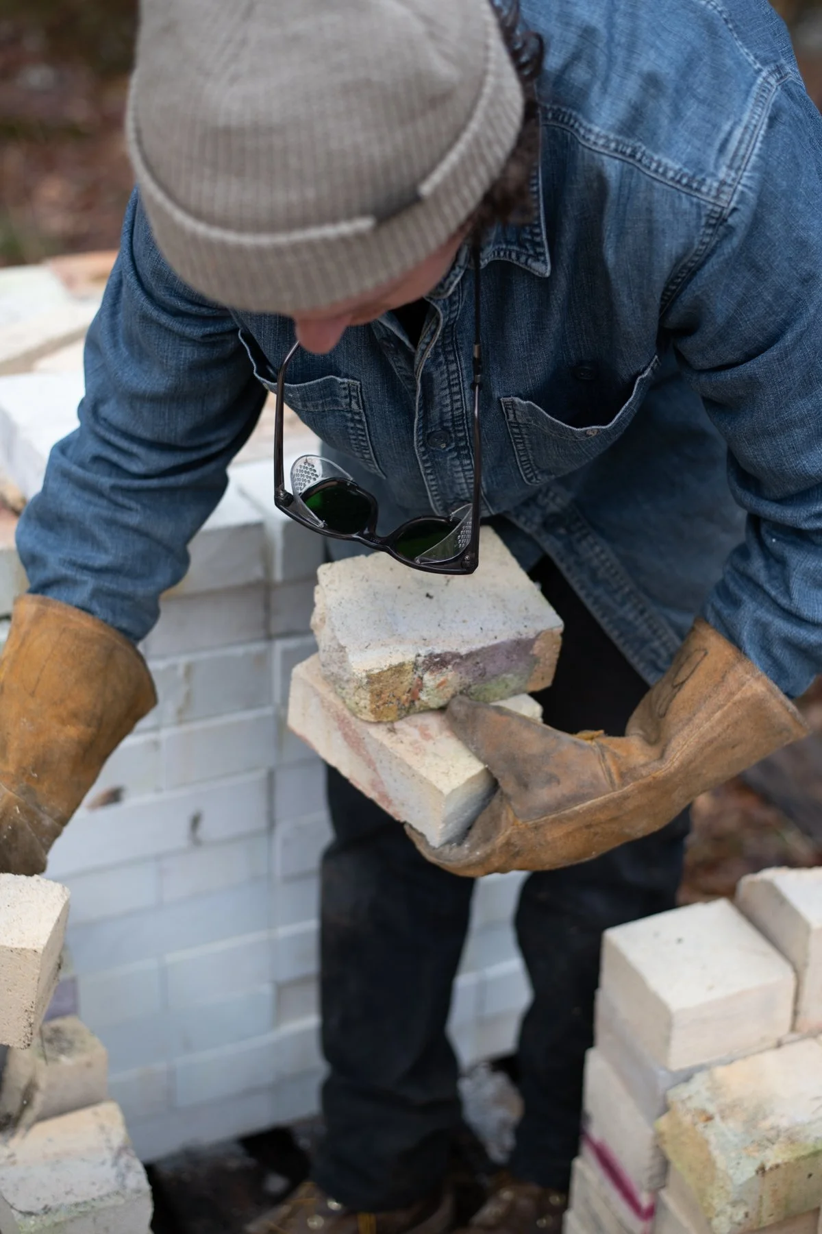 holding bricks with leather gloves
