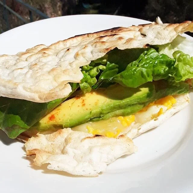 Breakfast of champs! Crispy sourdough pieradilla with semi aged sheep and cow cheese, scrambled eggs, avocado, cherry tomatoes (hiding), raw onion, romaine, cayenne pepper, squeeze of lemon 🌞🍋😋