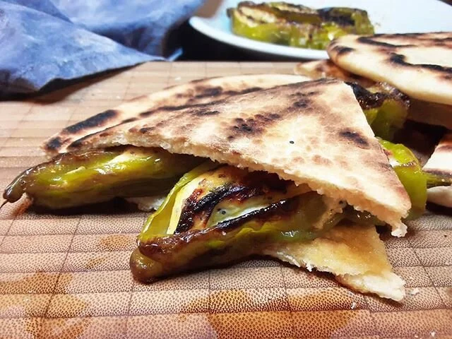 Torta al testo: a fermented  flat bred from the italian central region of Umbria, particularly the city of Perugia. Here filled with friggitelli peppers (similar to shishito or piment&oacute;n) that were stuffed with ricotta, walnuts and mint. We mad