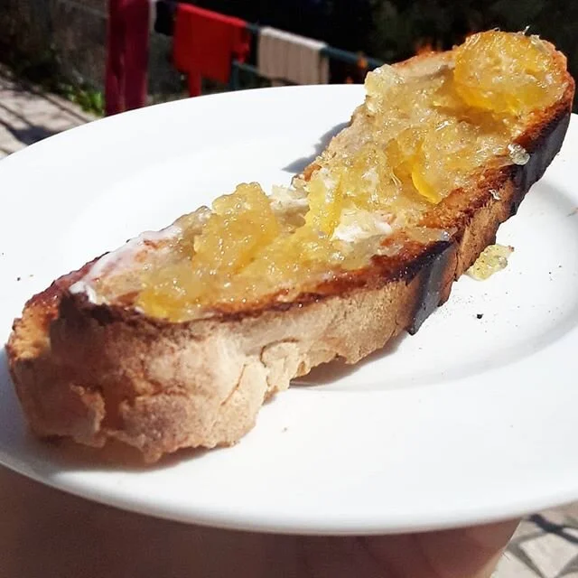 Slice of heaven. Homemade lemon jam from the garden, butter, toasted caraway sourdough (1/3 whole wheat, 2/3 white flour)