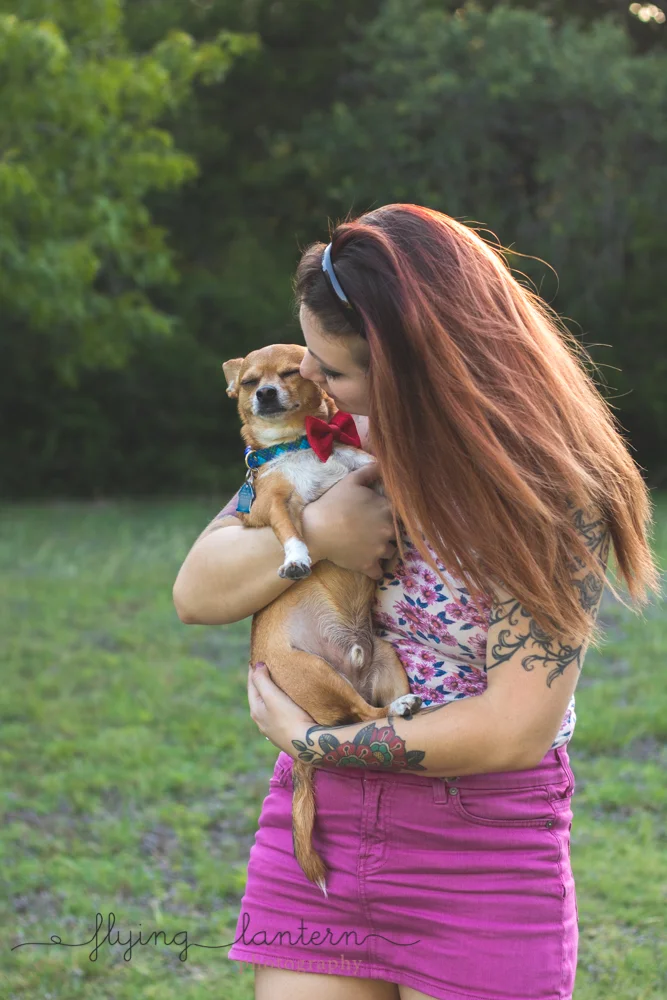 owner cuddling dog standing up