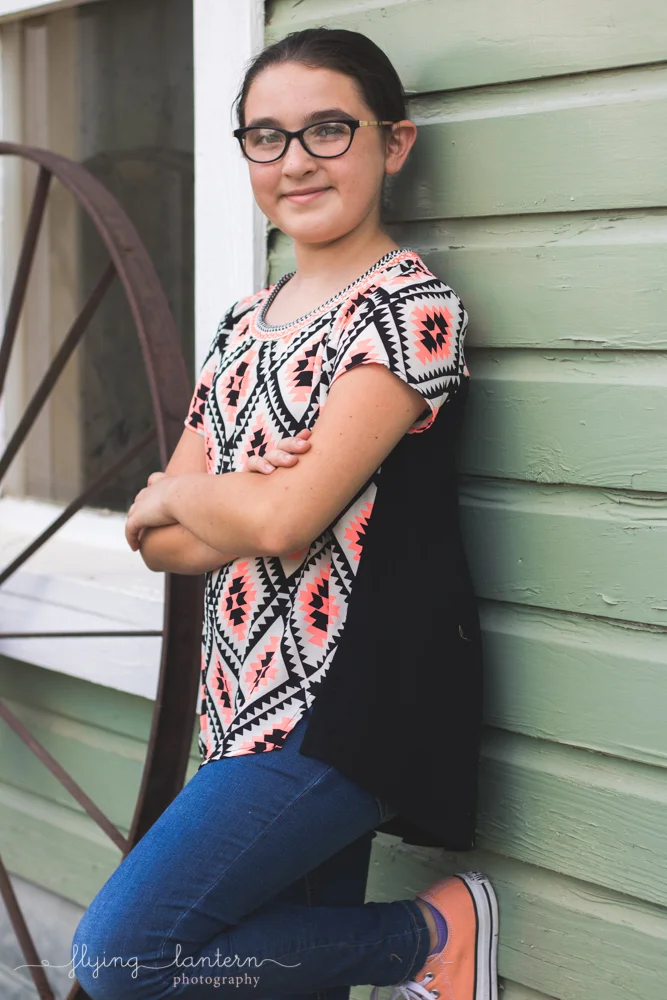 twelve year old leaning against wall
