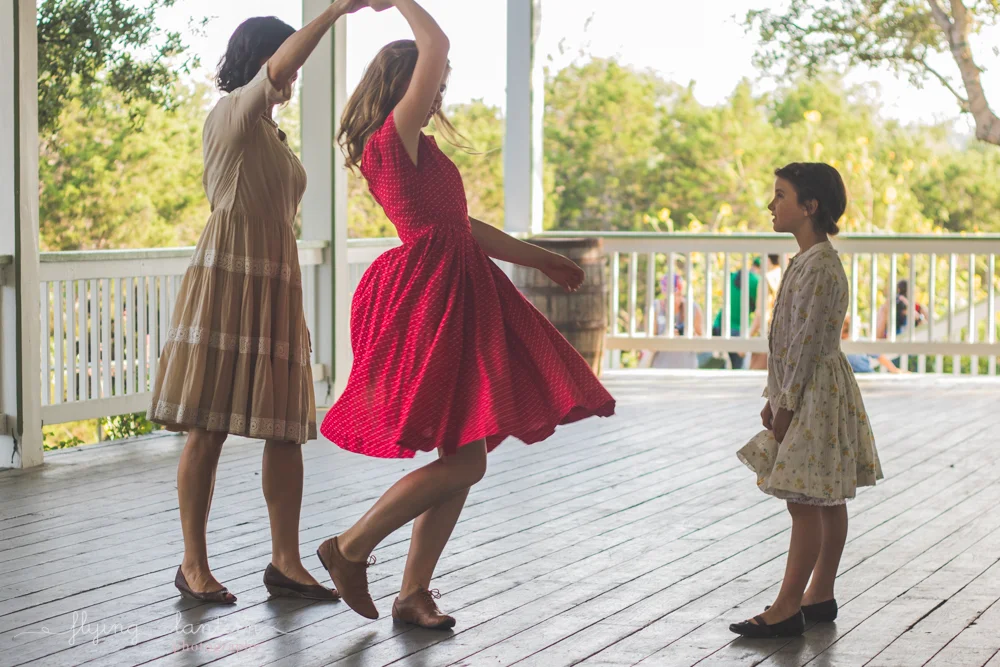 mother twirling daughters