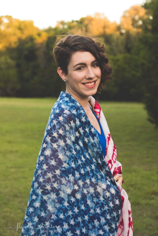 audra facing side with flag around shoulders looking at camera