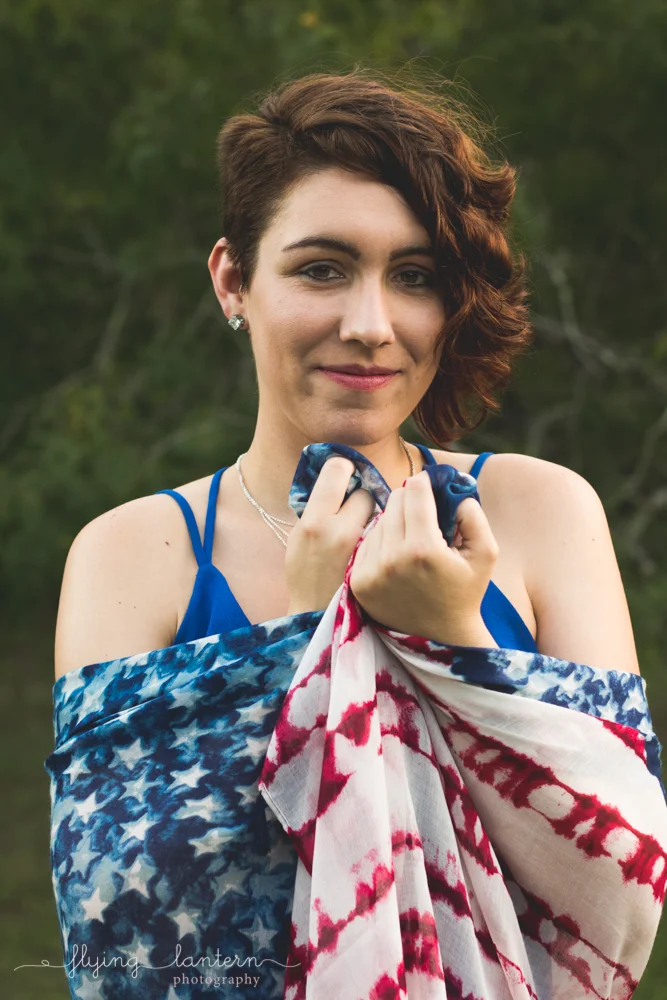 girl portrait holding flag in hands up to face