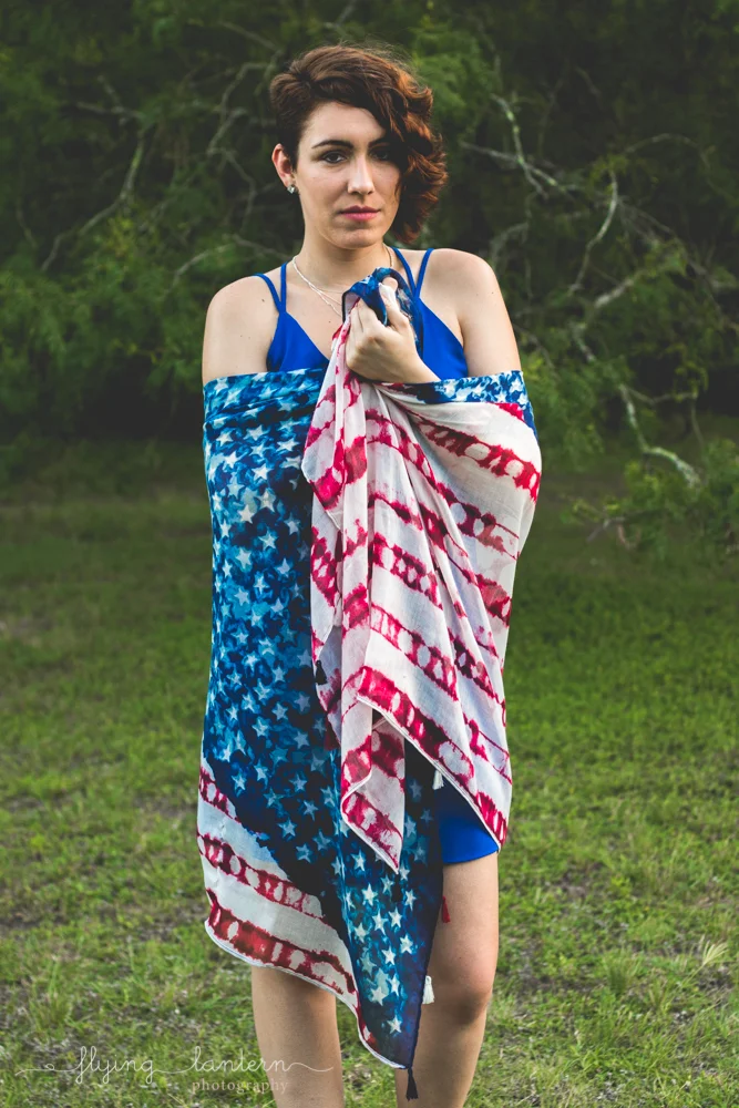 girl portrait with American flag wrapped around her