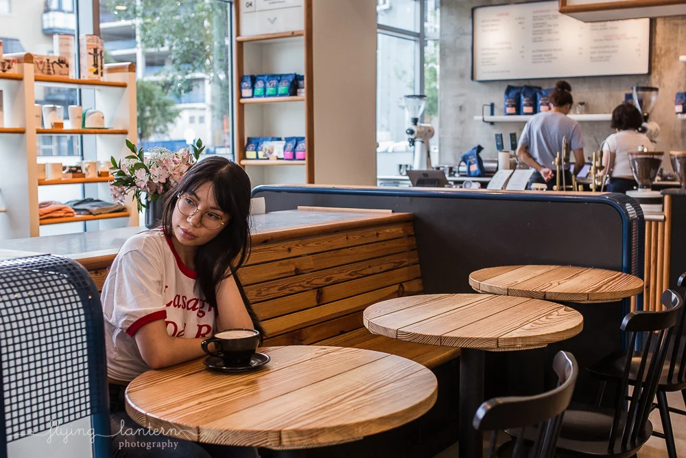 girl portrait in austin, texas at merit coffee shop holding coffee mug photo by erin reas of flying lantern photography