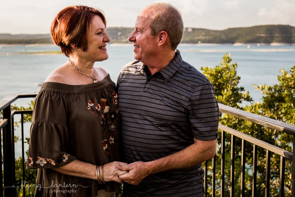 Extended family session on Lake Travis during family reunion. parents portrait smiling and holding hands. Photo by Erin Reas of Flying Lantern Photography
