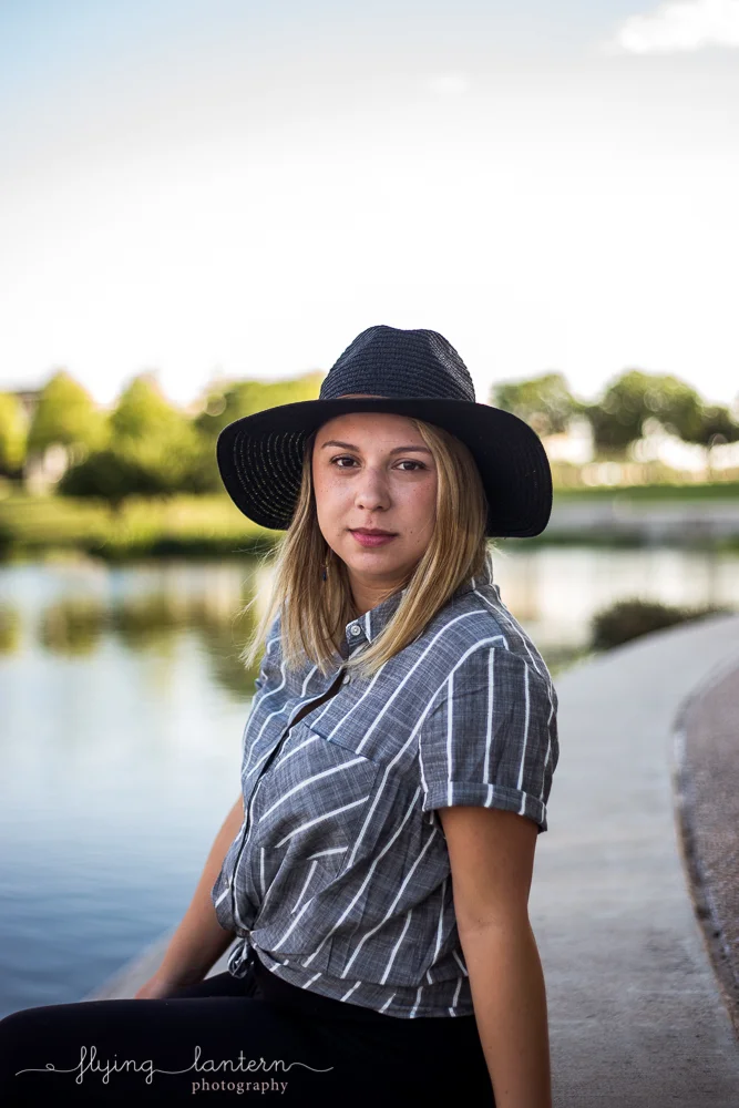 Austin food blogger lifestyle portrait session at Mueller Lake Park. Headshot. Woman wearing striped grey top and black hat. Photo by Erin Reas of Flying Lantern Photography