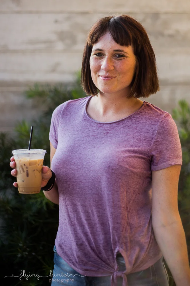 Austin blogger outside Halcyon holding coffee