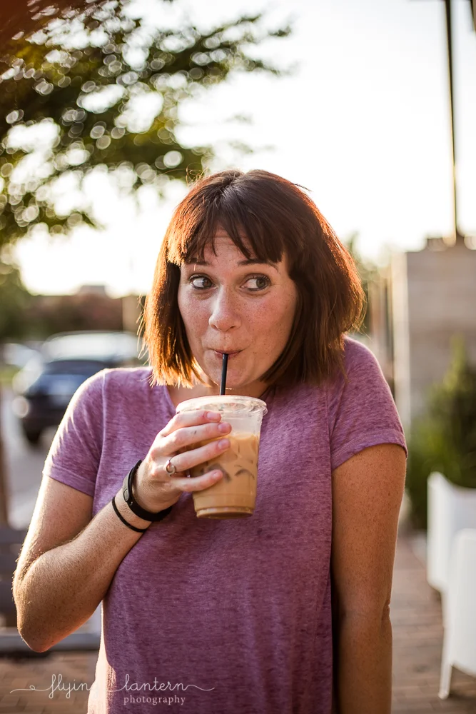 Austin blogger outside Halcyon holding coffee and making facial expressions