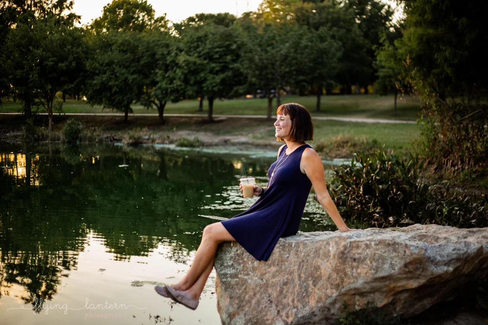 Austin blogger at mueller lake park lifestyle portrait sitting on rock looking out to lake photography by Erin Reas of Flying Lantern Photography
