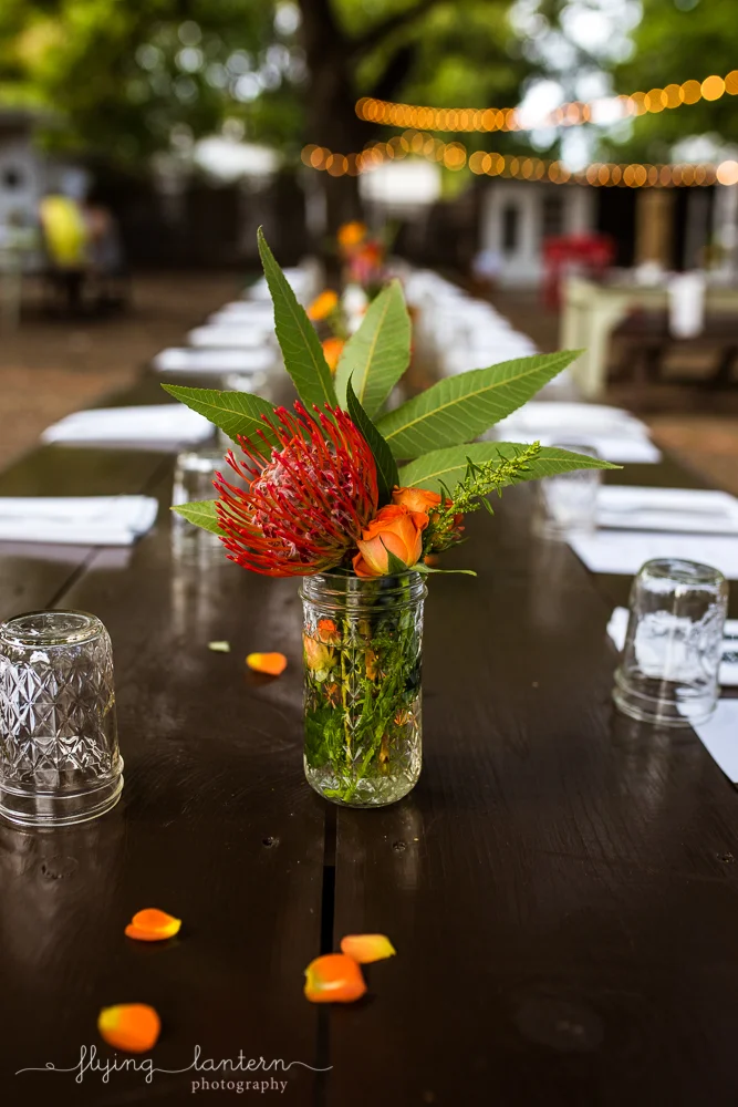 Flower arrangement with wildflowers in mason jar at Wander/Gather event at Eden East in Austin, TX. Photo by Erin Reas of Flying Lantern Photography.