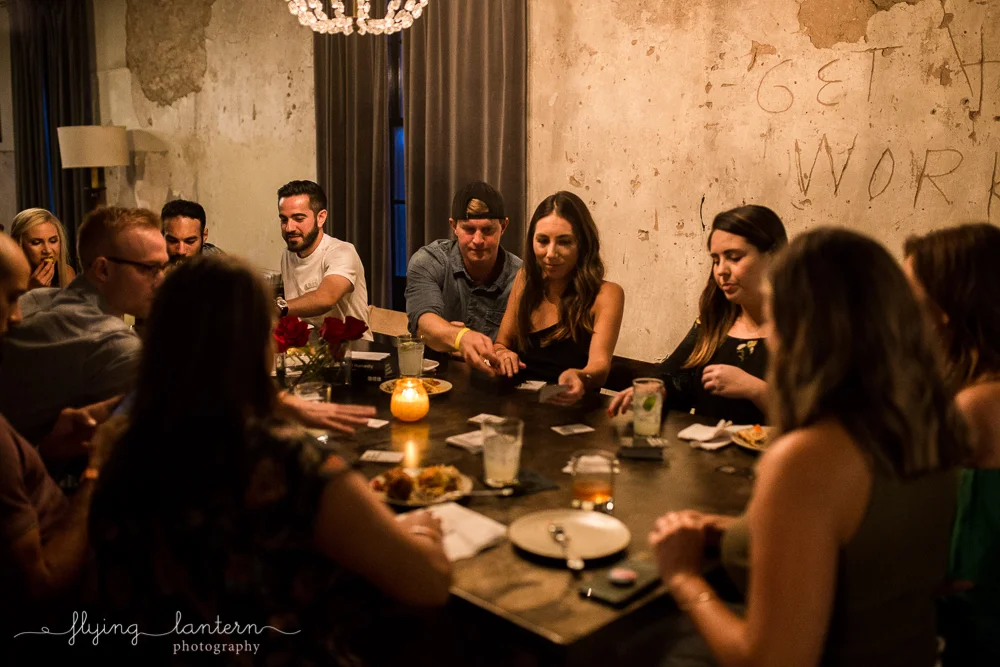 Friends around table playing Cards Against Humanity at Native Hostel. Photo by Erin Reas of Flying Lantern Photography