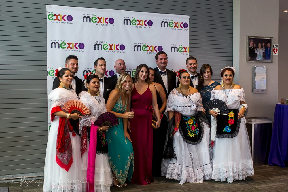 Fiesta dancers posing with guests at the Authentic Mexico Gourmet Gala. Event Photography by Erin Reas.
