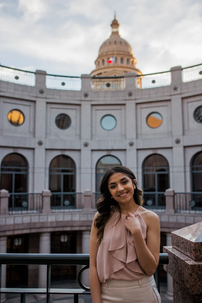 college graduate senior portrait in texas state capitol building. inside the rotunda of the capitol building. photo by erin reas austin photographer