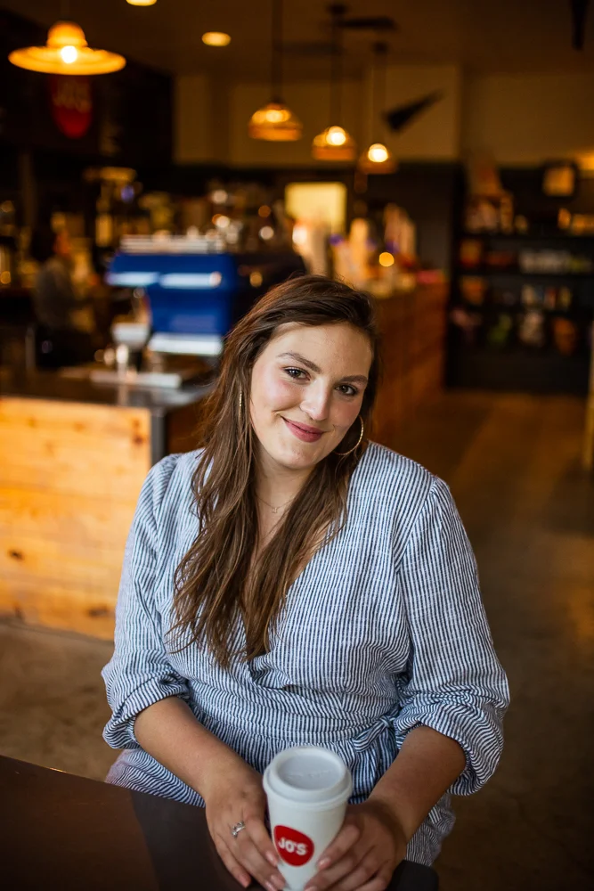 Female college student in Jo’s coffee shop on St. Edward’s University campus. Photo by Erin Reas senior photographer