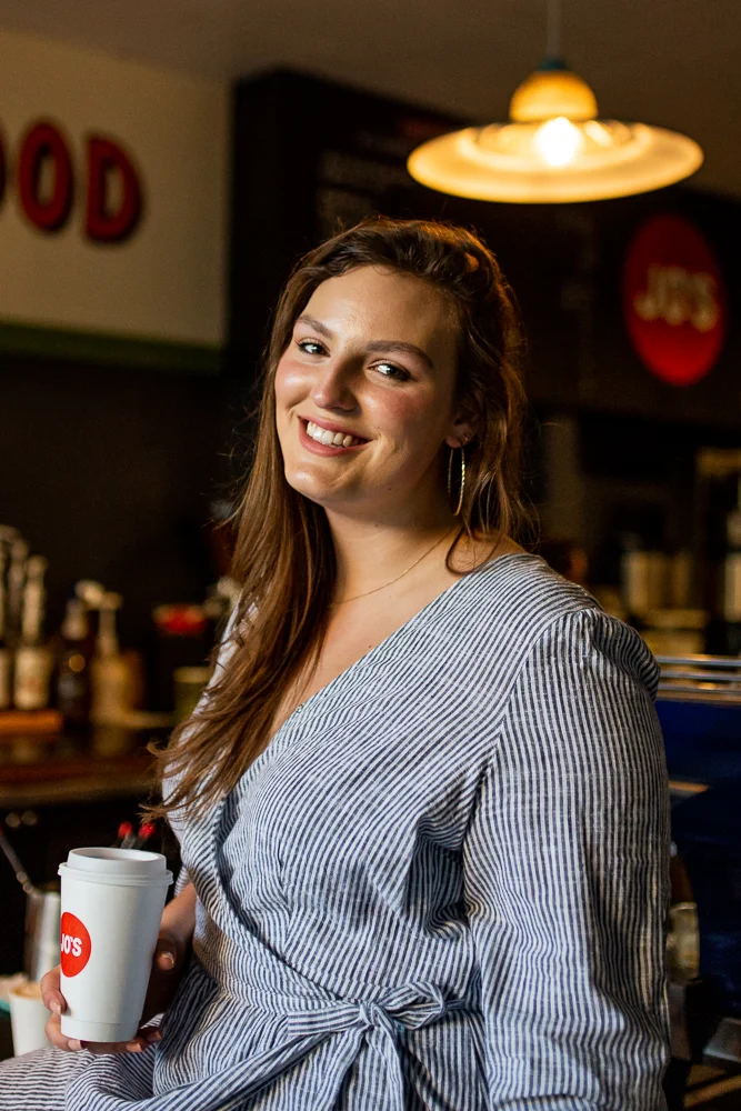Female college student in Jo’s coffee shop on St. Edward’s University campus. Photo by Erin Reas senior photographer