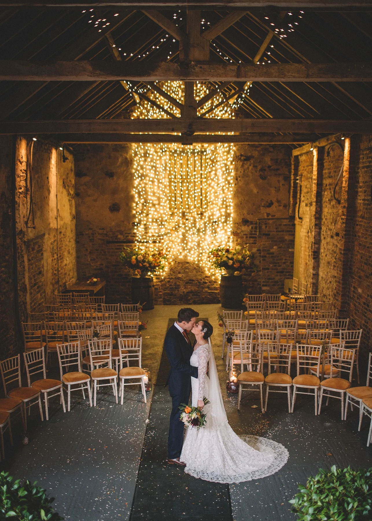 Rachel & Andrew by Lumiere Photographic - Rachel and Andrew steal a kiss in the Ceremony Barn.jpg