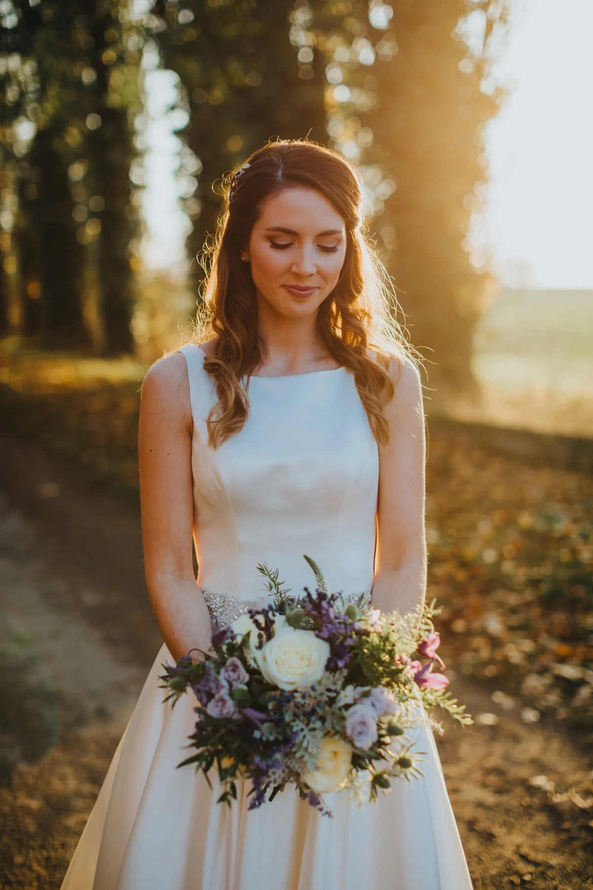 Bride Holly takes a moment in the autumn light.jpg