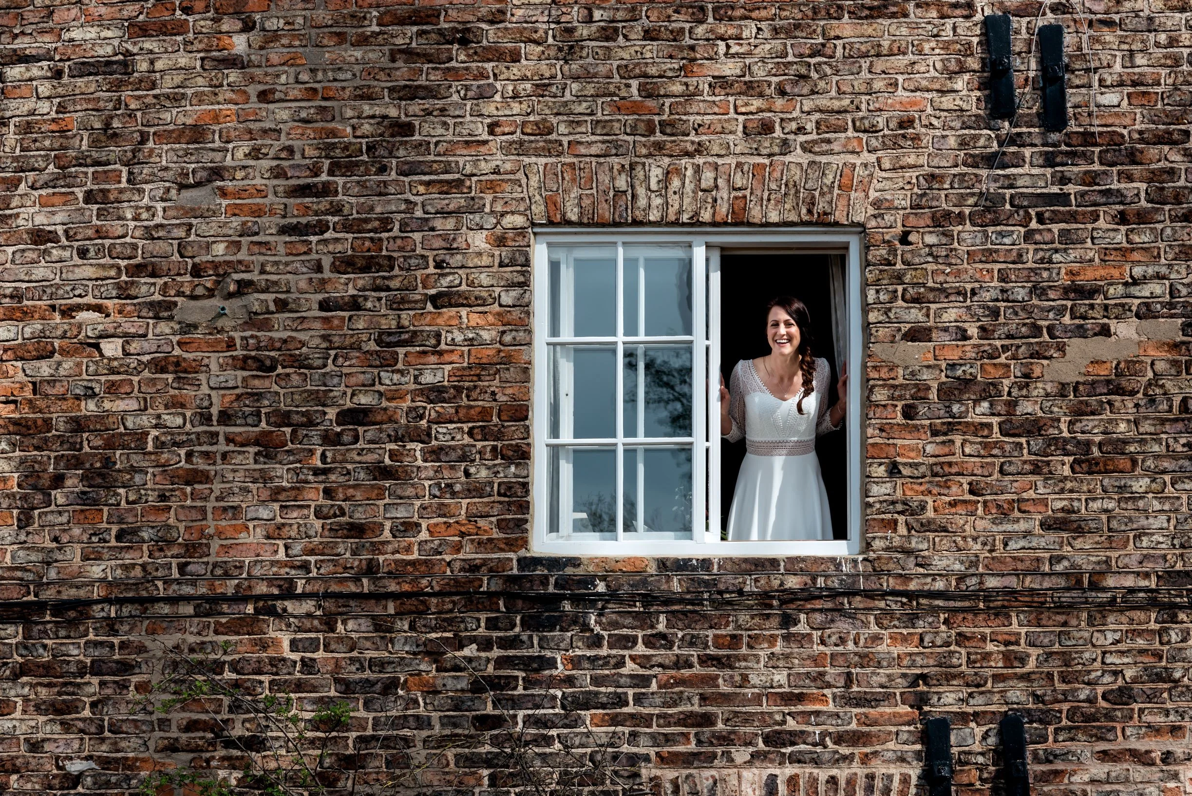 Laura greets the adoring masses from the window of The Normans Cottage.jpg