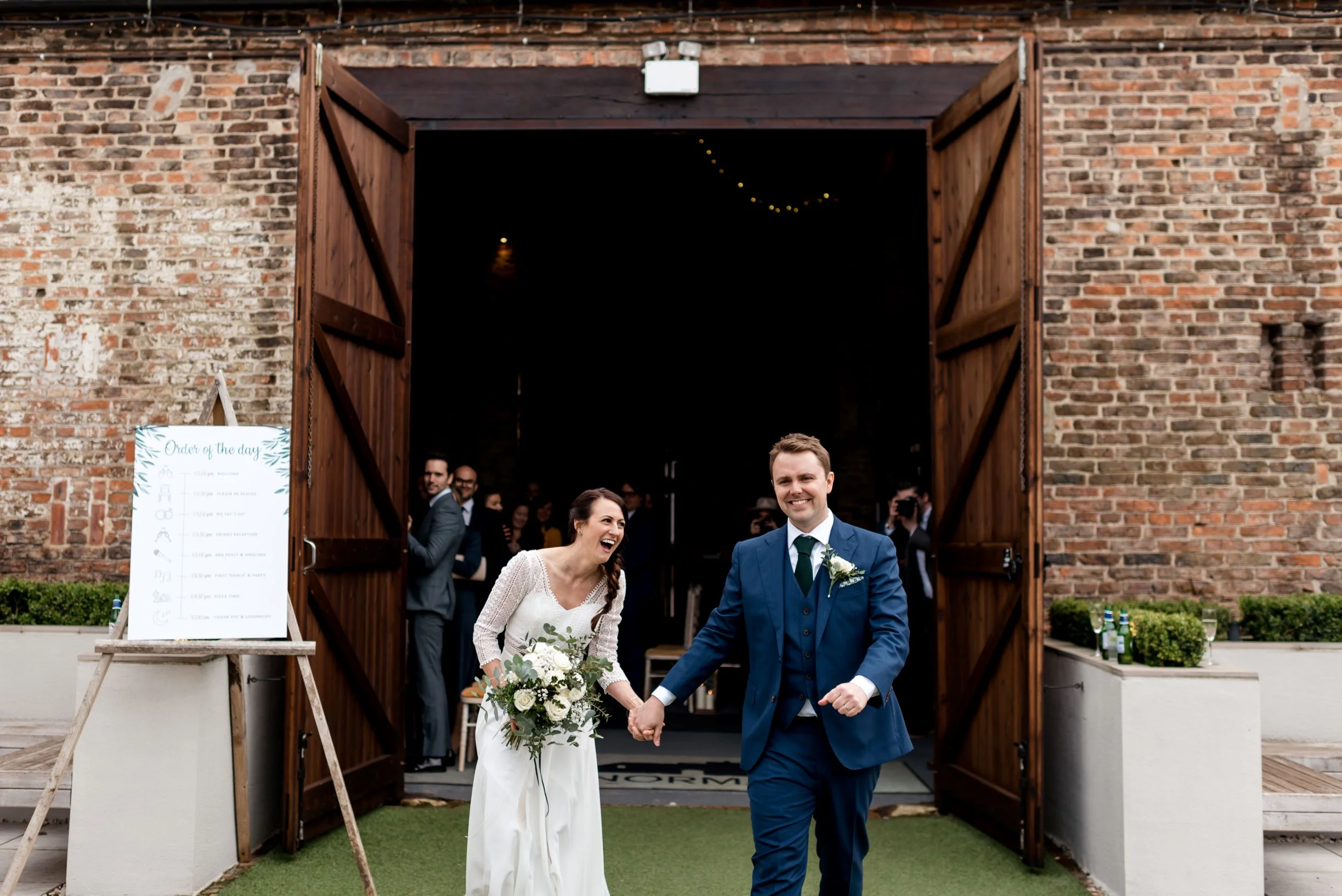 Lols all round as James and Laura emerge from The Normans Ceremony Barn as man and wife.jpg