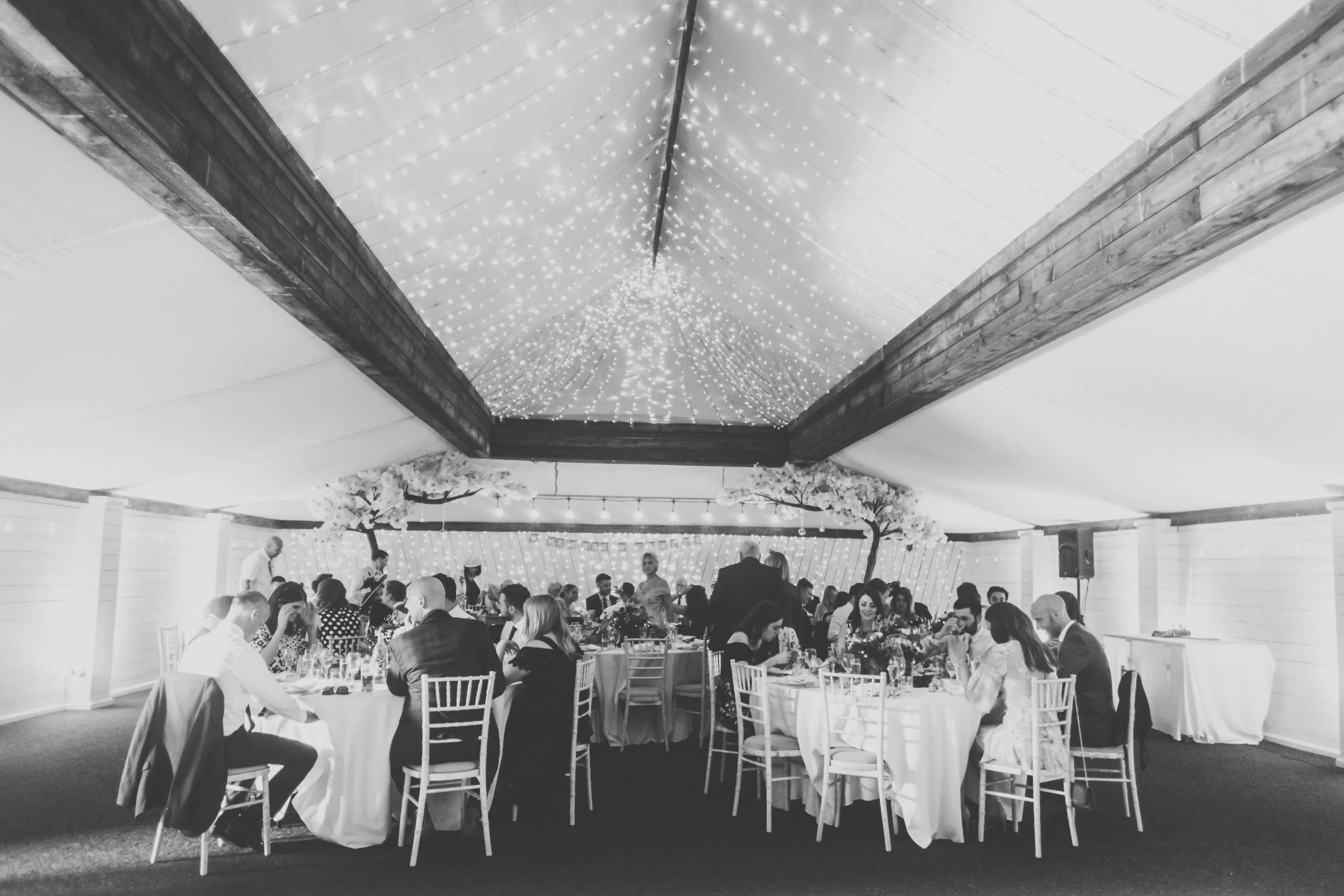 The Normans Grain Shed looking stunning with blossom trees and circular tables.jpg