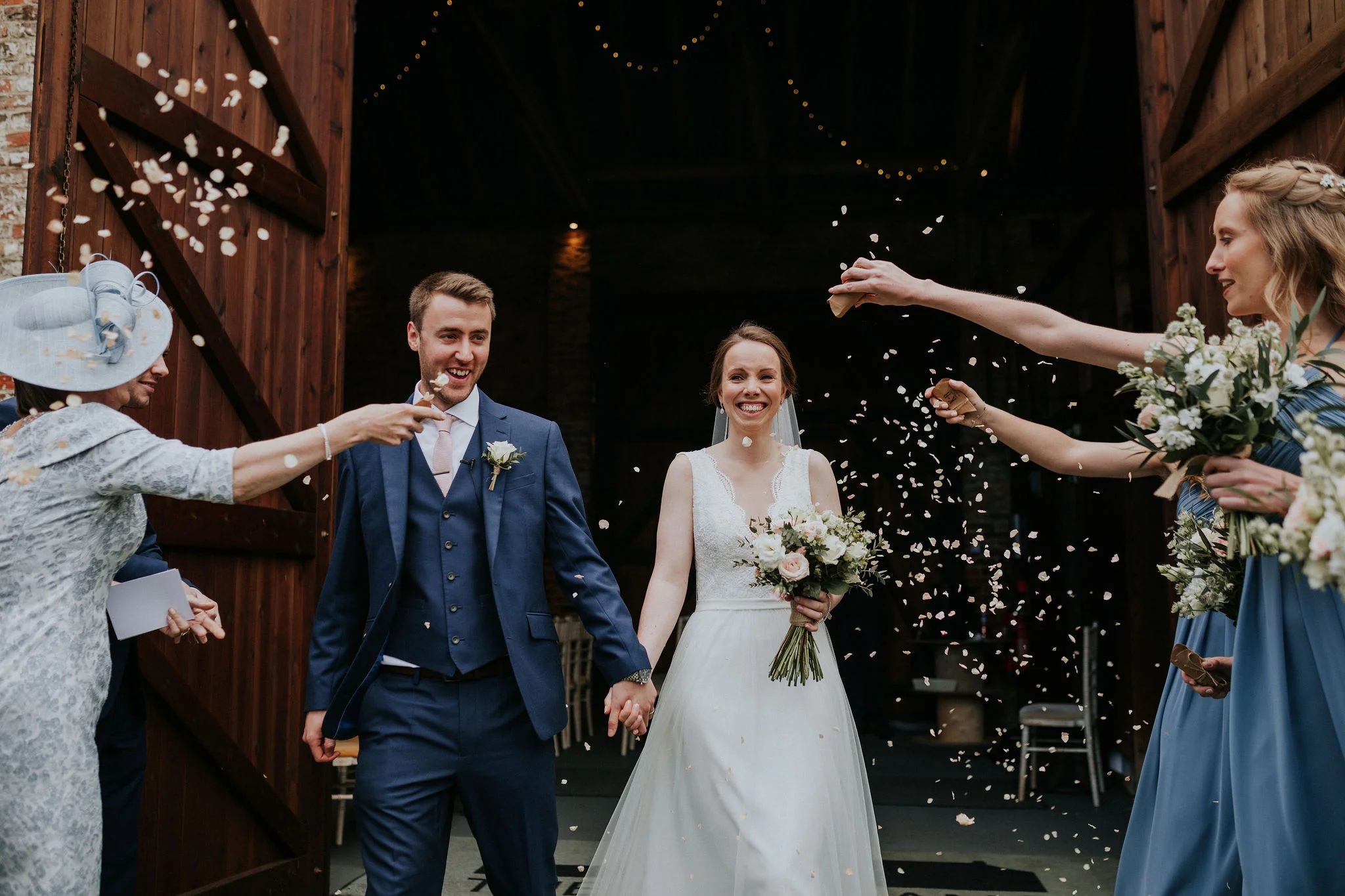 Confetti swirls in the breeze outside The Normans Ceremony Barn.jpg