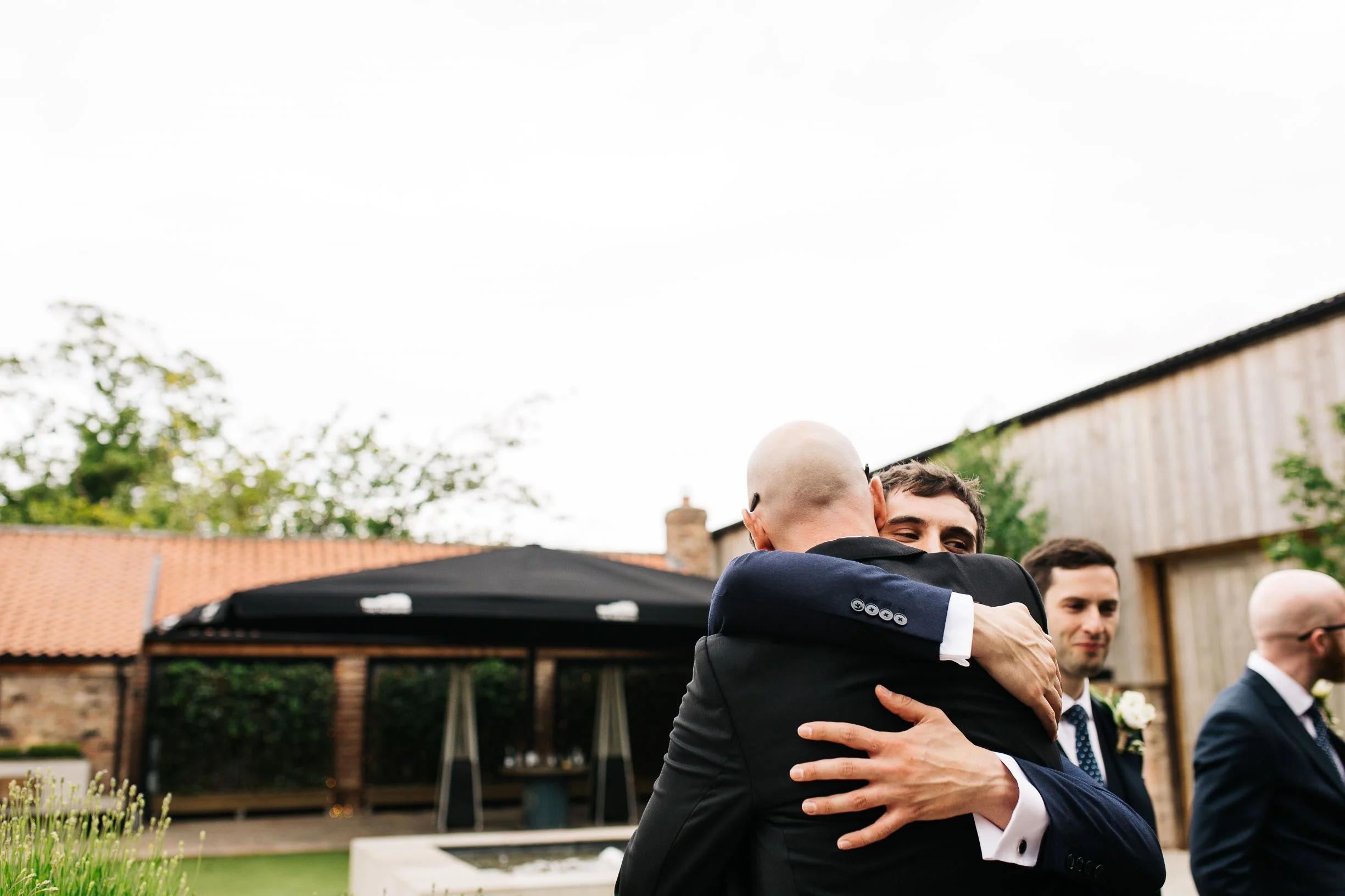 Man hugs in The Normans Courtyard. Photo by pauljosephphotography.co.uk.jpg