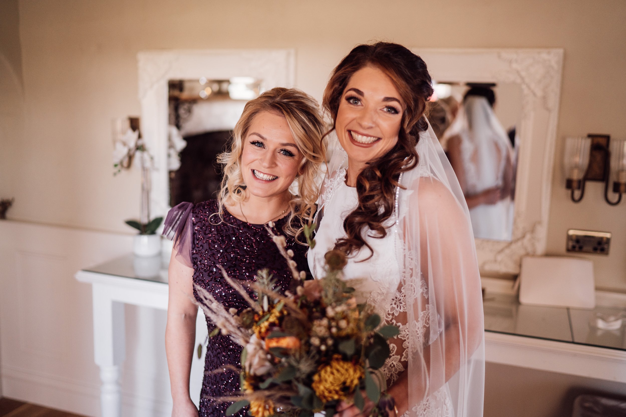 El and her bridesmaid dressed in sparkling purple. Photo bloomweddings.co.uk.jpg