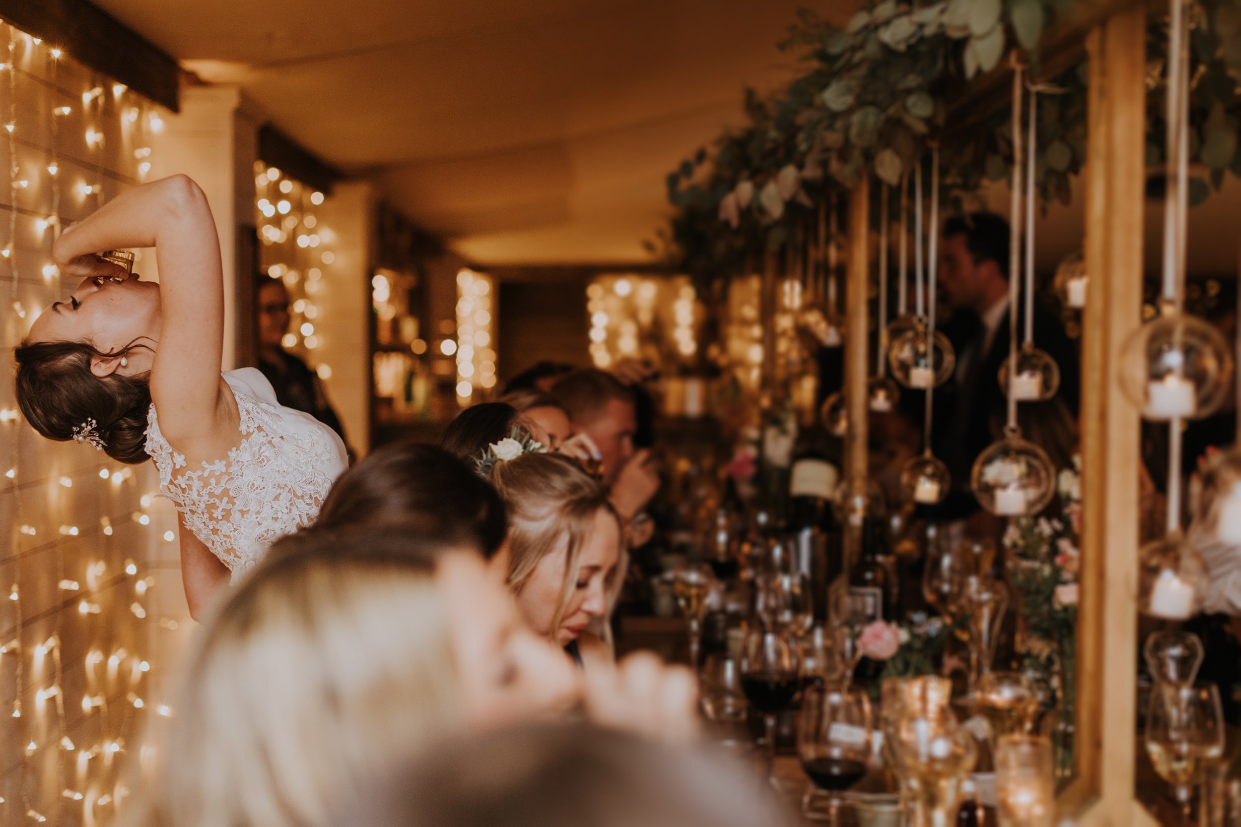 The bride knocks back a shot at The Normans wedding.jpg