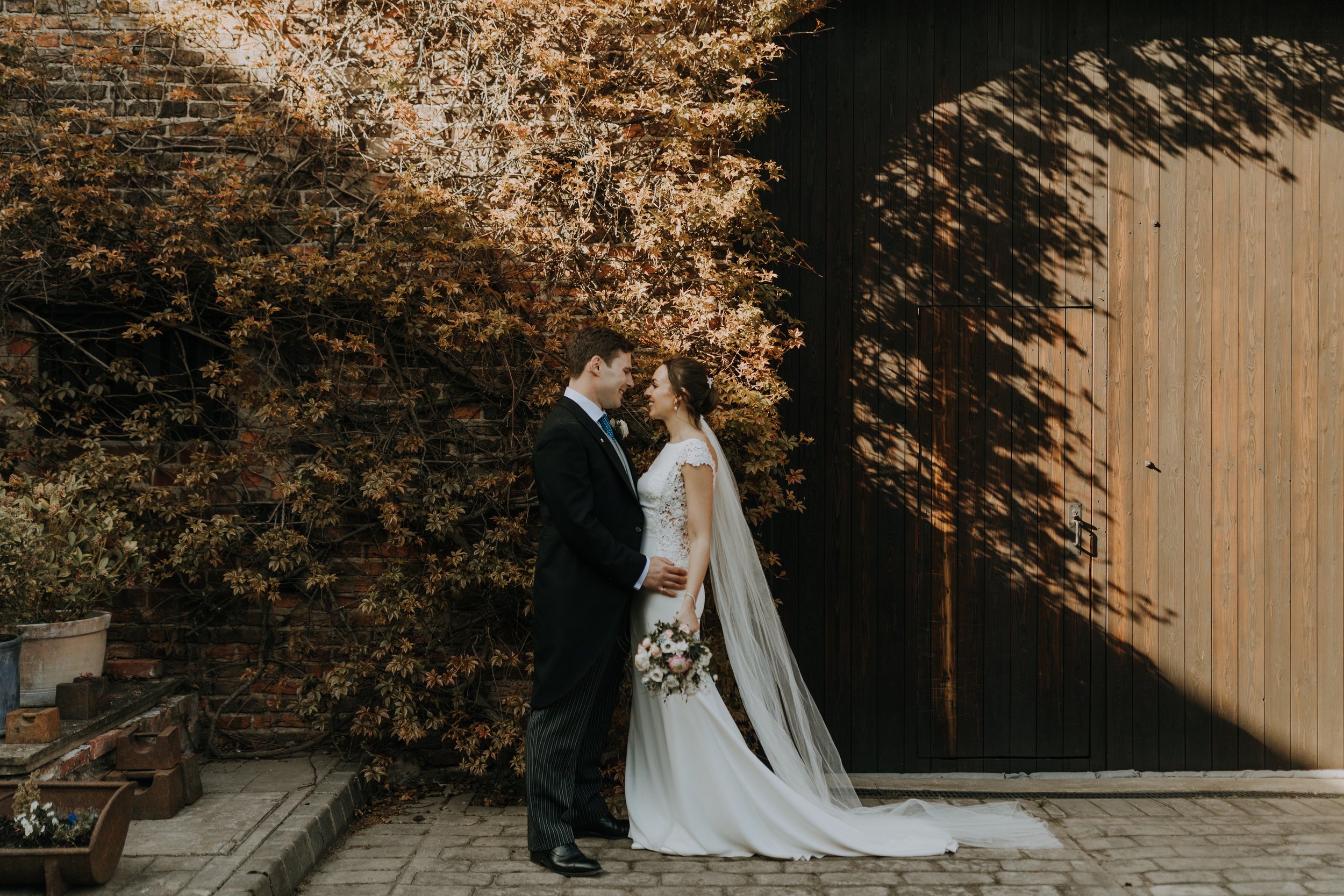Stunning Bride and Groom explore the grounds surrounding The Normans. Photo by Louise Anna Photography.jpg