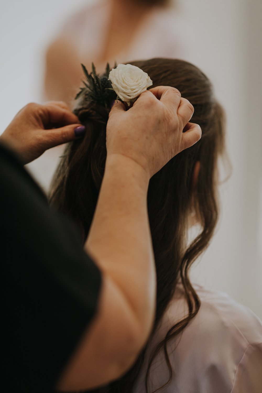 Helen Griffin Hair applies the finishing touches to bride Maria's hair. Photo by Louise Anna Photography.jpg