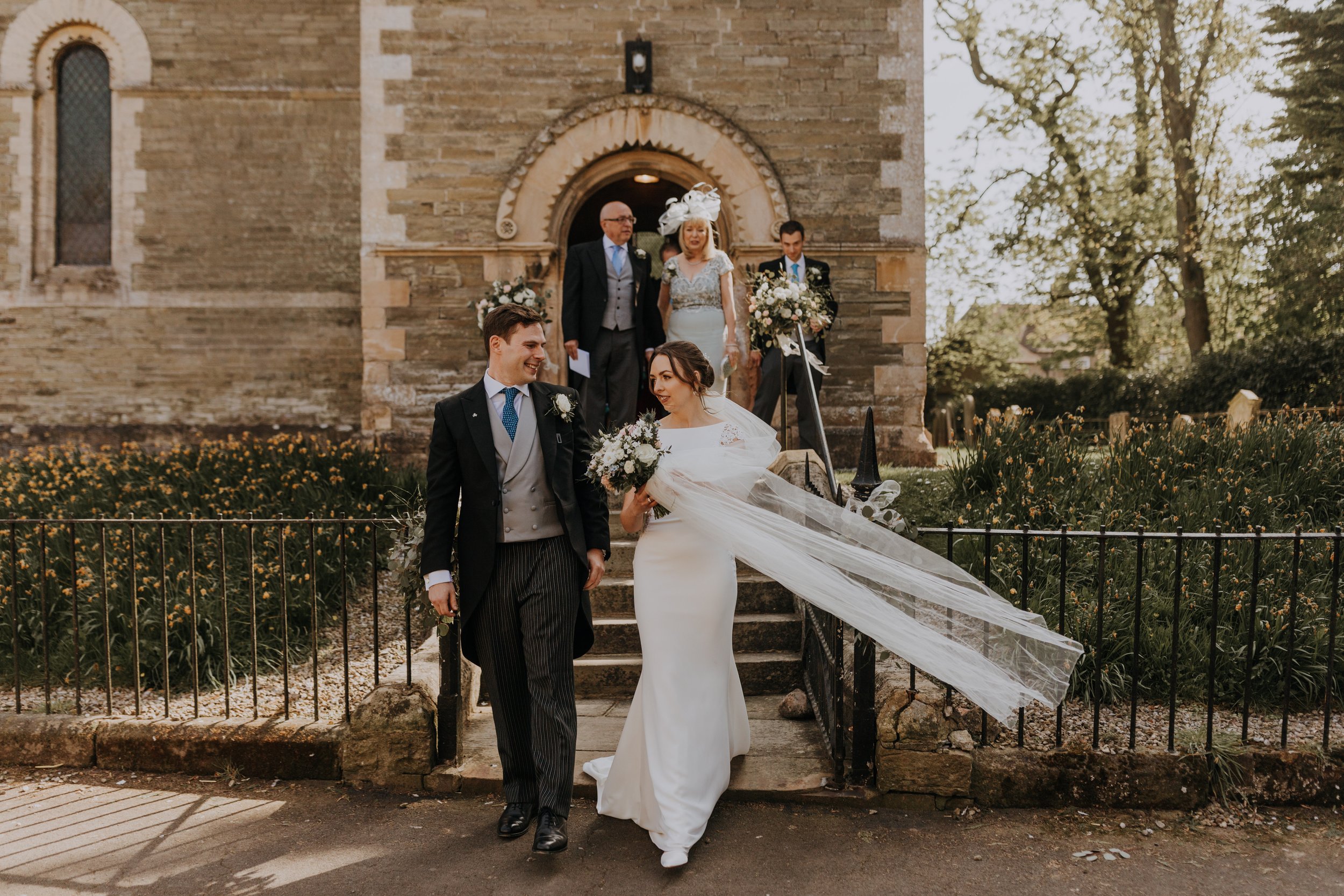 Maria and Tom after their church ceremony before heading to The Normans wedding venue. Photo by Louise Anna Photography.jpg