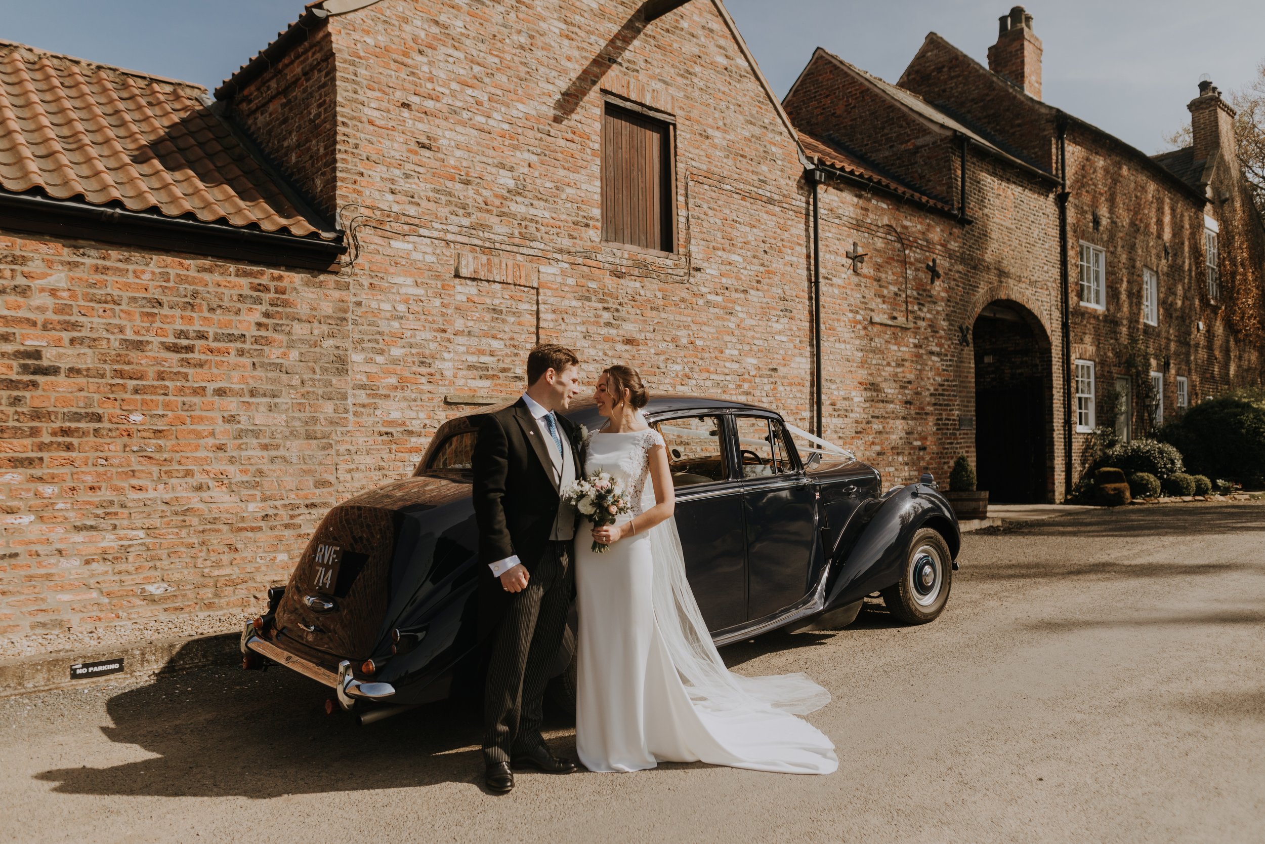 Bride and Groom arrive in style at The Normans wedding venue. Photo by Louise Anna Photography.jpg