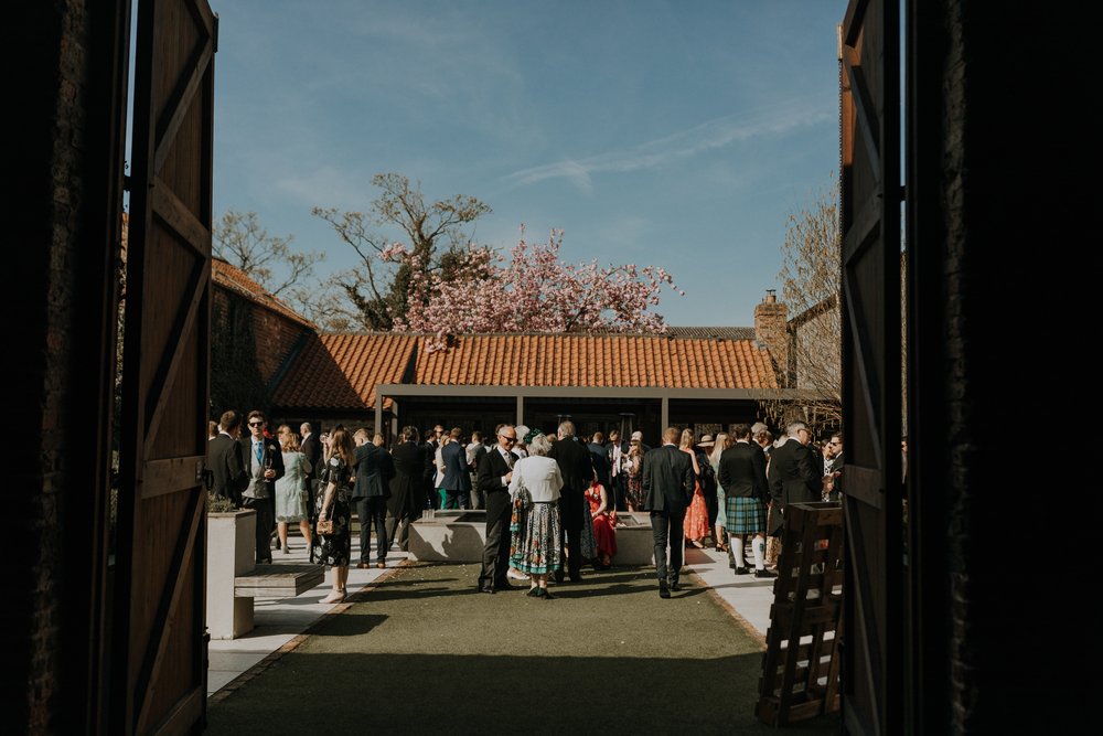Looking out from The Ceremony Barn into The Courtyard at The Normans wedding venue. Photo by Louise Anna Photography.jpg